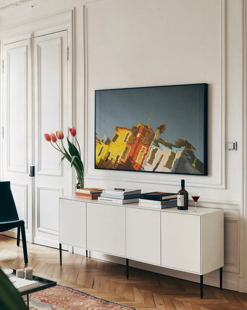 Reflections of Burano XI by Aledanda. shown as a framed stretched canvas in a living room above a console. Available as a archival giclee rolled canvas, fine art paper, or poster print. SKU 41604i.