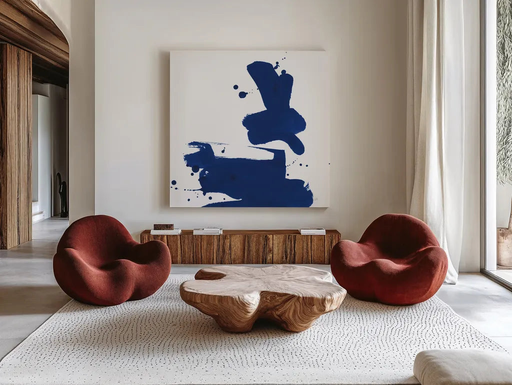 Cobalt Ink Drops III by Chris Paschke. Shown as extra-large giant wall art in a modern living room. Available as an archival giclee rolled canvas, fine art paper, or poster print. SKU 67370a.