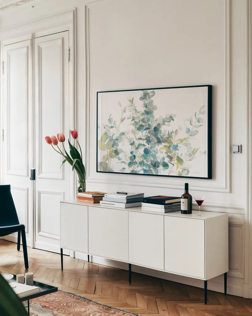 Eucalyptus I White Crop by Danhui Nai. shown as a framed stretched canvas in a living room above a console. Available as a archival giclee rolled canvas, fine art paper, or poster print. SKU 35489i.