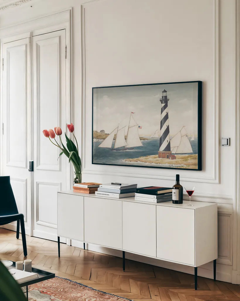 Hatteras Light by David Carter Brown. shown as a framed stretched canvas in a living room above a console. Available as a archival giclee rolled canvas, fine art paper, or poster print. SKU 37654i.