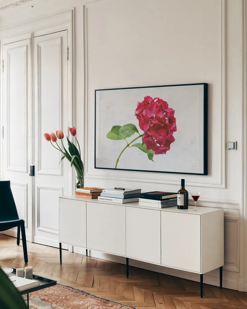 Bright Red Hydrangea by Deborah Revell. shown as a framed stretched canvas in a living room above a console. Available as a archival giclee rolled canvas, fine art paper, or poster print. SKU 93154i.
