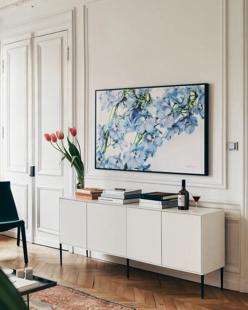 Freshly Picked Delphinium II by Elizabeth Urquhart. shown as a framed stretched canvas in a living room above a console. Available as a archival giclee rolled canvas, fine art paper, or poster print. SKU 67967i.