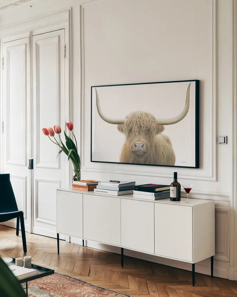 Highland Cow on White by James Wiens. shown as a framed stretched canvas in a living room above a console. Available as a archival giclee rolled canvas, fine art paper, or poster print. SKU 50230i.