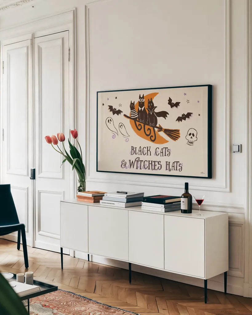 Spooktacular I Witches Hats by Janelle Penner. shown as a framed stretched canvas in a living room above a console. Available as a archival giclee rolled canvas, fine art paper, or poster print. SKU 49062i.