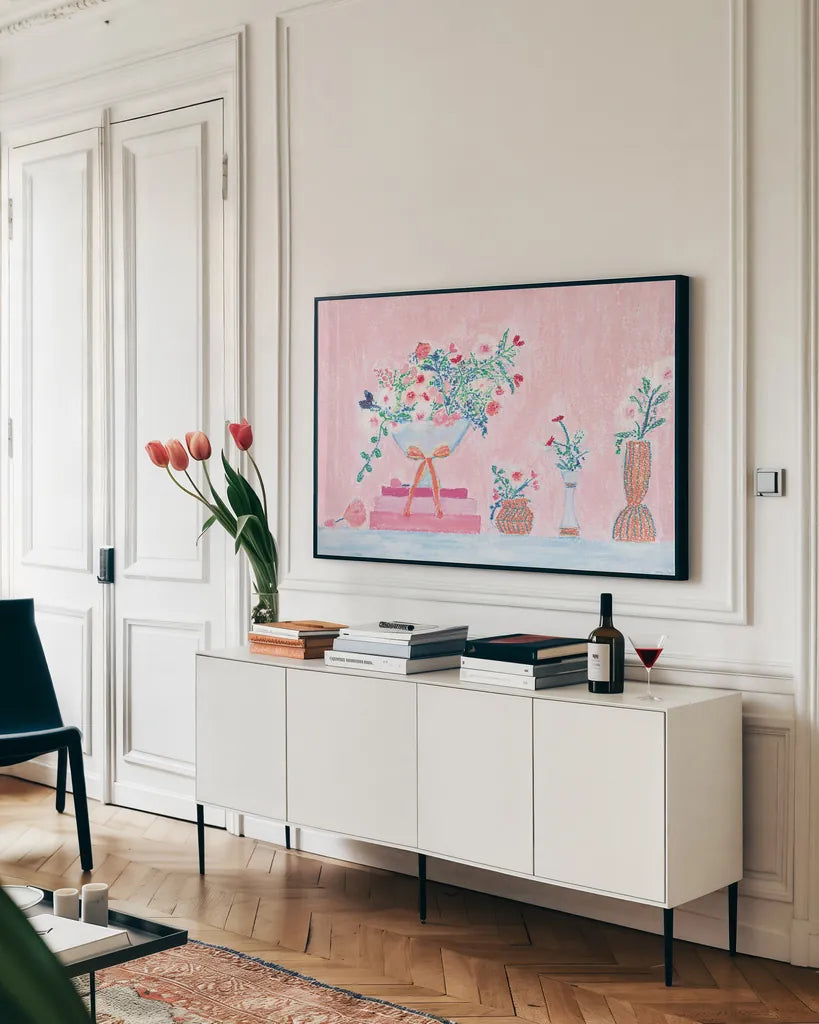 Flower Vases and Books Pink by Jocelyn Elizabeth. shown as a framed stretched canvas in a living room above a console. Available as a archival giclee rolled canvas, fine art paper, or poster print. SKU 100970i.