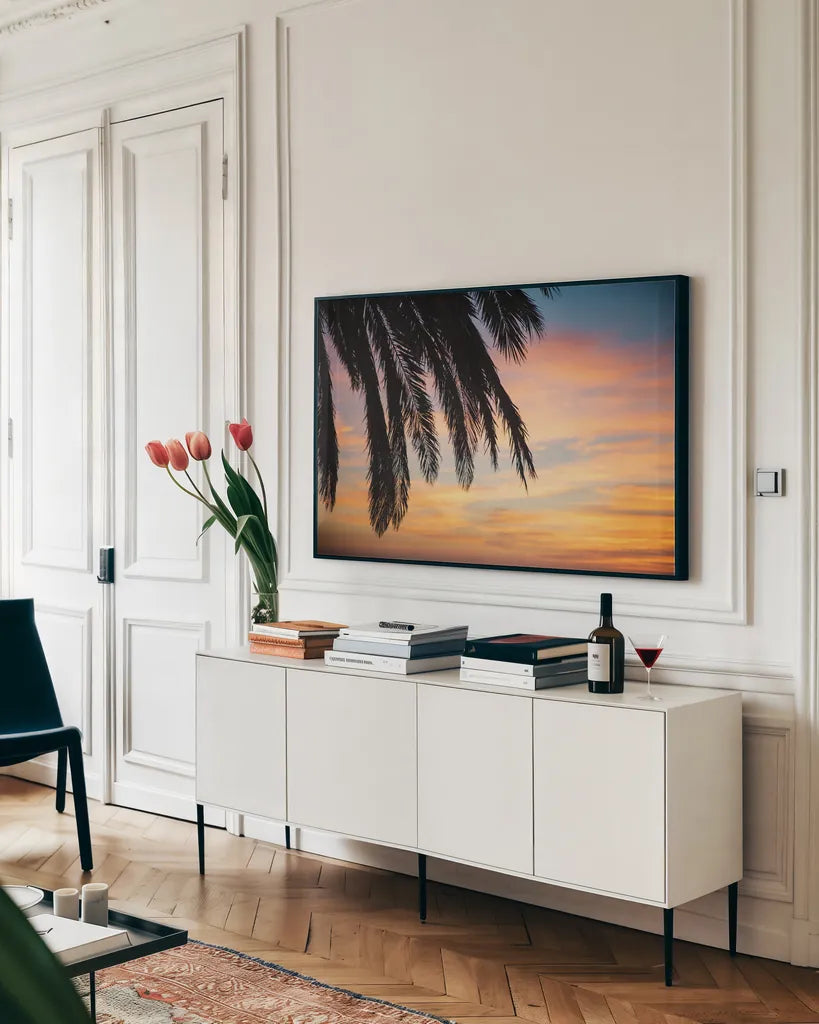 Sunset Palms I by Laura Marshall. shown as a framed stretched canvas in a living room above a console. Available as a archival giclee rolled canvas, fine art paper, or poster print. SKU 42851i.