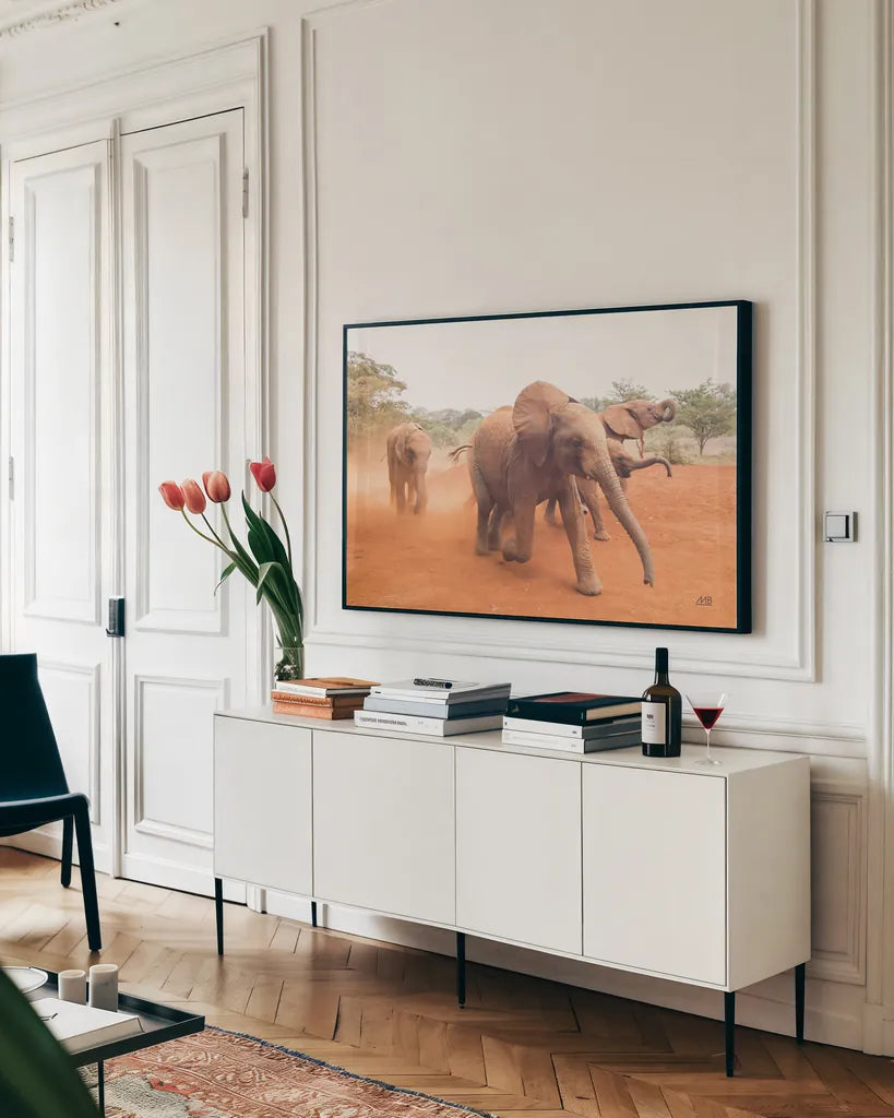 Elephant Race by Max Blakesberg Studios. shown as a framed stretched canvas in a living room above a console. Available as a archival giclee rolled canvas, fine art paper, or poster print. SKU 93614i.