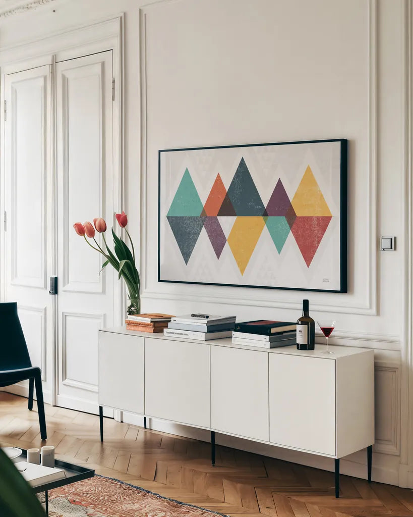 Mod Triangles II Retro by Michael Mullan. shown as a framed stretched canvas in a living room above a console. Available as a archival giclee rolled canvas, fine art paper, or poster print. SKU 53844i.