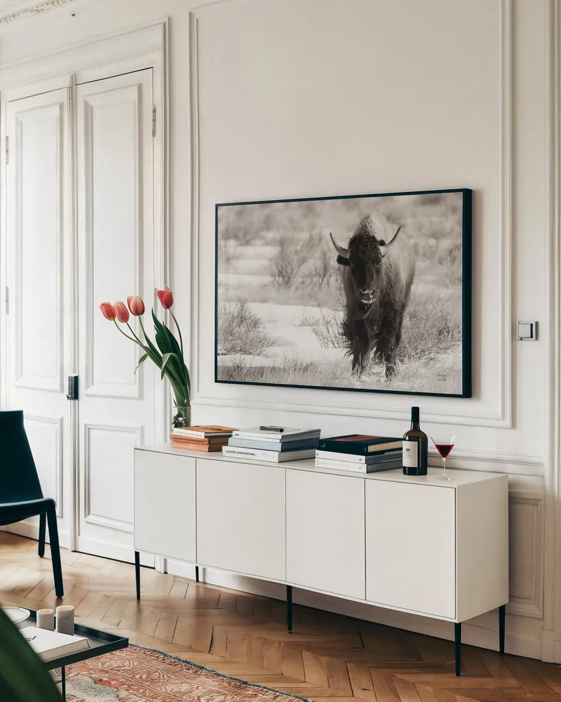Bison Beauty BW by Nathan Larson. shown as a framed stretched canvas in a living room above a console. Available as a archival giclee rolled canvas, fine art paper, or poster print. SKU 84321i.