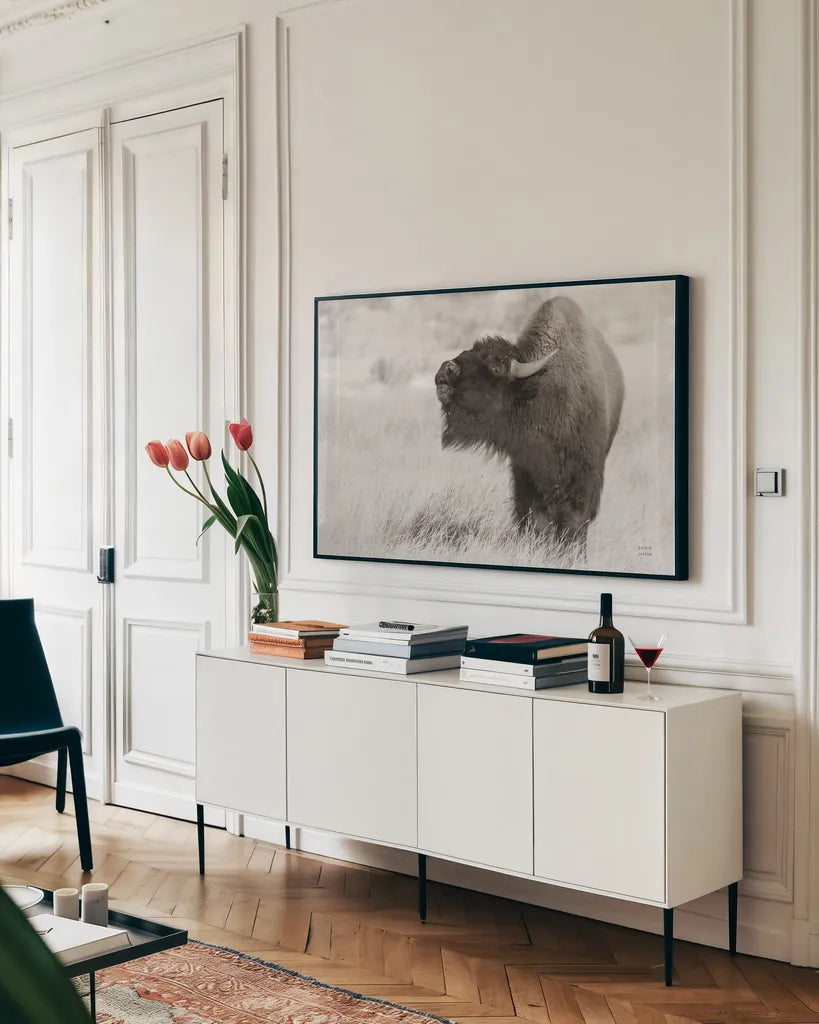 Bison Call BW by Nathan Larson. shown as a framed stretched canvas in a living room above a console. Available as a archival giclee rolled canvas, fine art paper, or poster print. SKU 84258i.