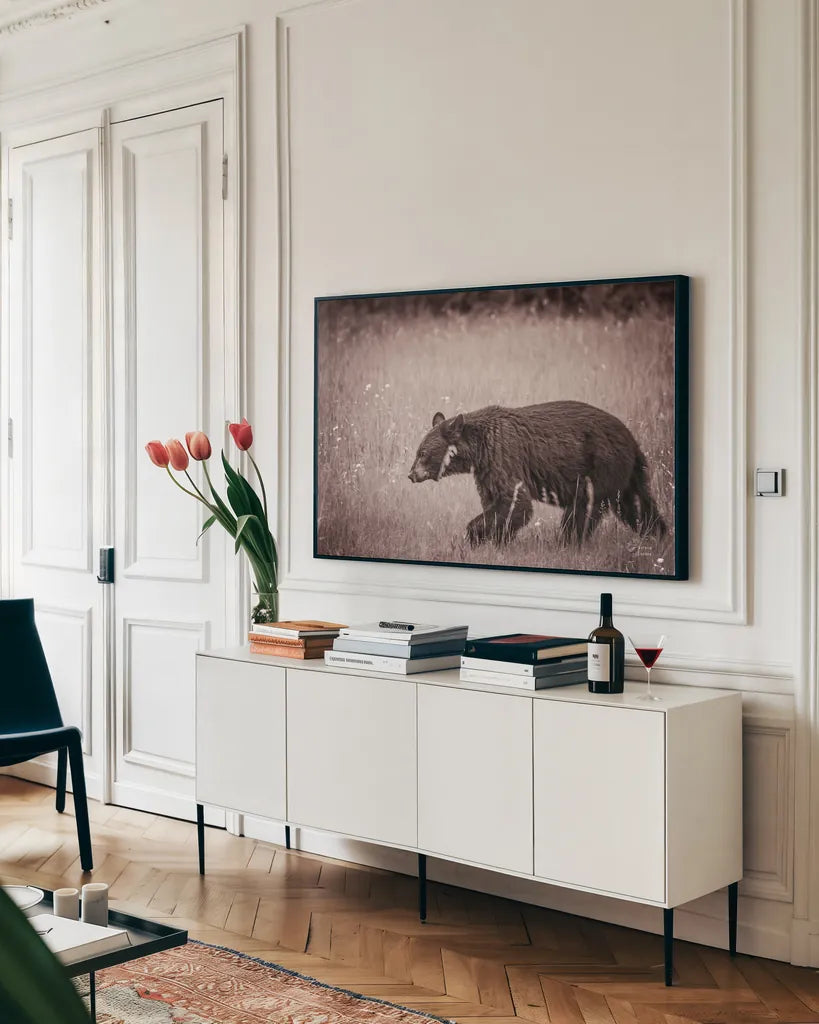 Black Bear in British Columbia Sepia Tones by Nathan Larson. shown as a framed stretched canvas in a living room above a console. Available as a archival giclee rolled canvas, fine art paper, or poster print. SKU 93388i.