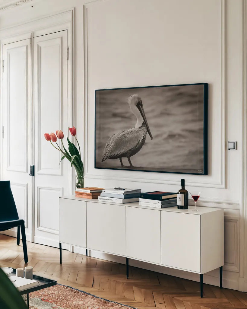 Brown Pelican by Nathan Larson. shown as a framed stretched canvas in a living room above a console. Available as a archival giclee rolled canvas, fine art paper, or poster print. SKU 97884i.