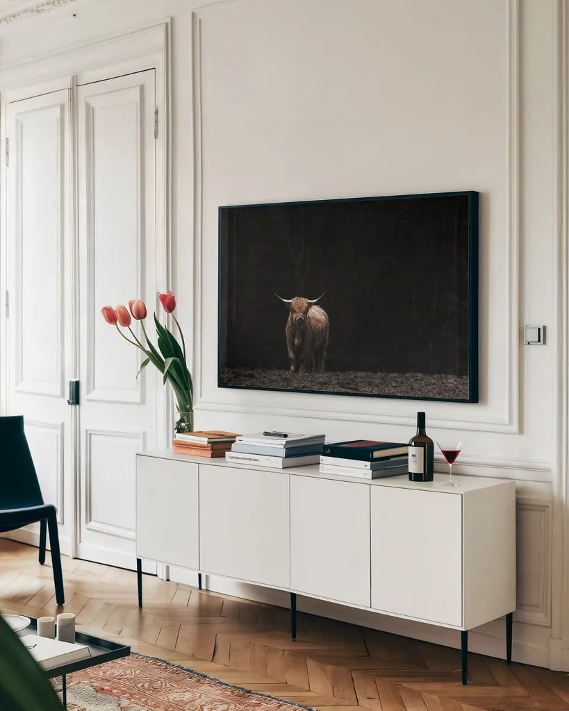 Highland Cow King of the Hill by Nathan Larson. shown as a framed stretched canvas in a living room above a console. Available as a archival giclee rolled canvas, fine art paper, or poster print. SKU 89477i.