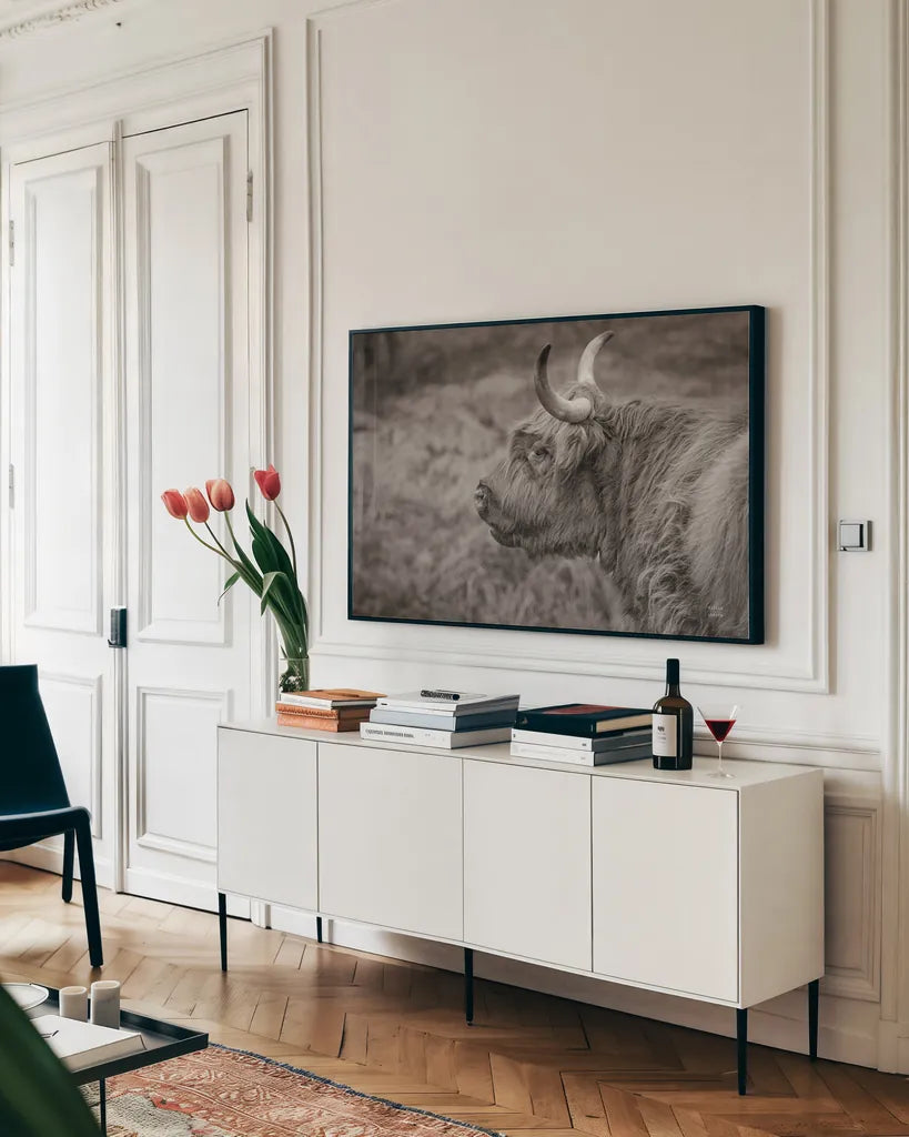 Highland Cow on Watch by Nathan Larson. shown as a framed stretched canvas in a living room above a console. Available as a archival giclee rolled canvas, fine art paper, or poster print. SKU 79109i.