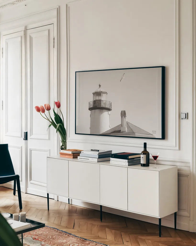 Lighthouse Fly Over by Nathan Larson. shown as a framed stretched canvas in a living room above a console. Available as a archival giclee rolled canvas, fine art paper, or poster print. SKU 87193i.