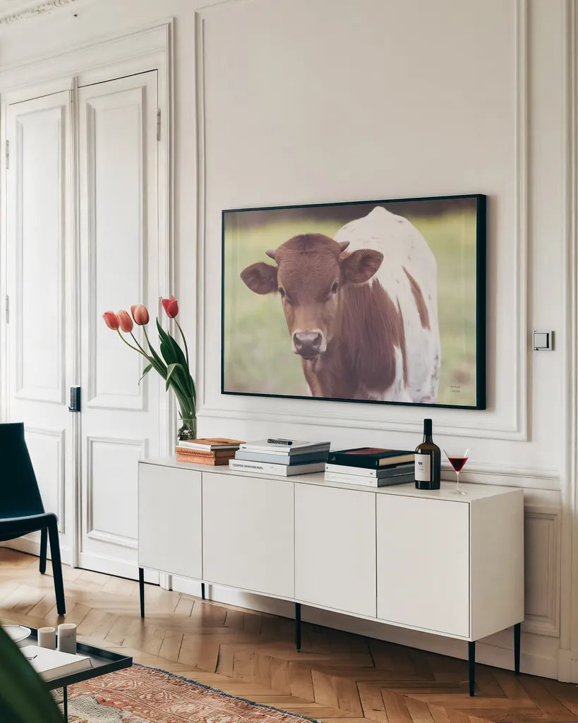 Little Longhorn by Nathan Larson. shown as a framed stretched canvas in a living room above a console. Available as a archival giclee rolled canvas, fine art paper, or poster print. SKU 92466i.