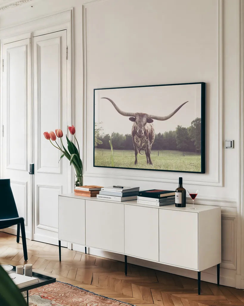 Longhorn Last Call by Nathan Larson. shown as a framed stretched canvas in a living room above a console. Available as a archival giclee rolled canvas, fine art paper, or poster print. SKU 91367i.