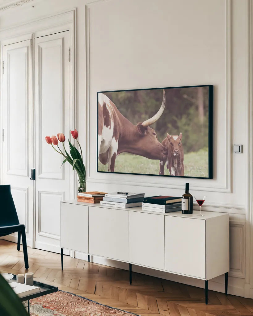 Longhorn Pasture Pair by Nathan Larson. shown as a framed stretched canvas in a living room above a console. Available as a archival giclee rolled canvas, fine art paper, or poster print. SKU 93356i.