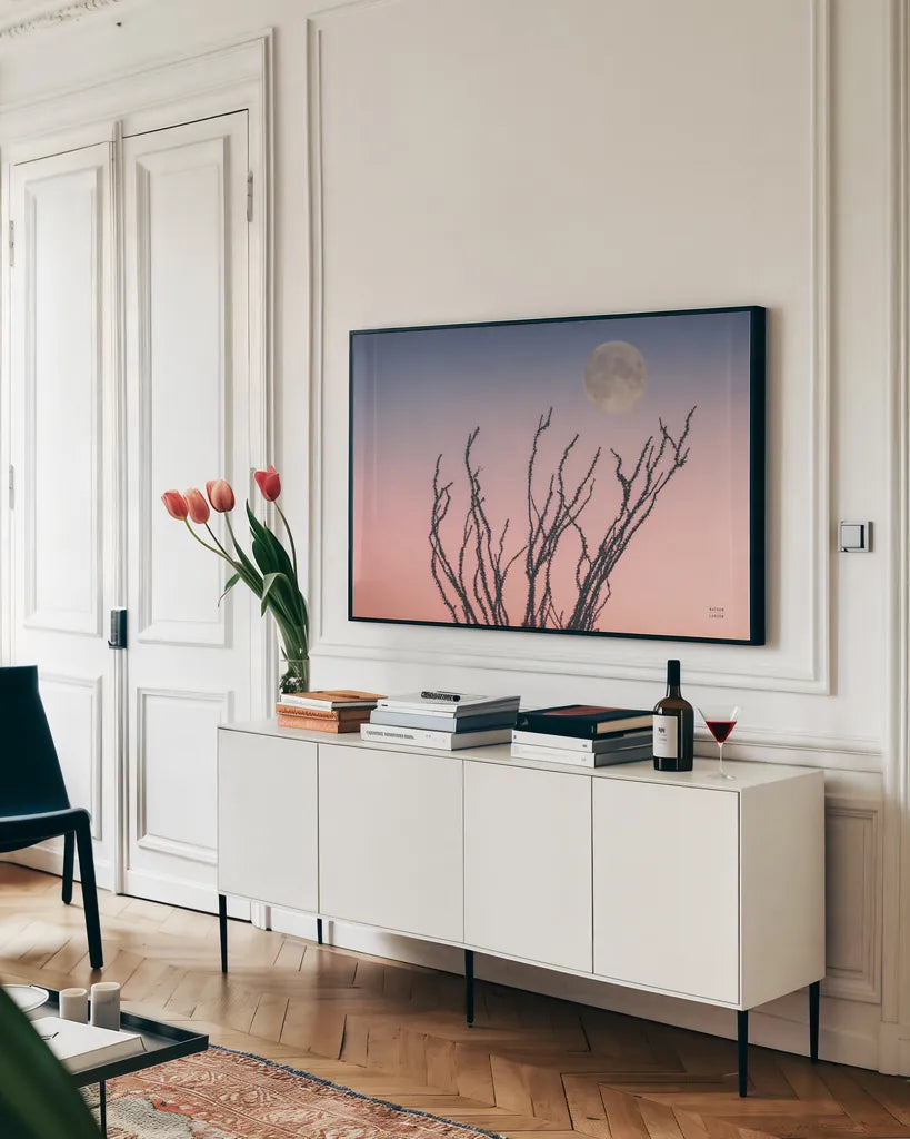 Reaching Up Moon by Nathan Larson. shown as a framed stretched canvas in a living room above a console. Available as a archival giclee rolled canvas, fine art paper, or poster print. SKU 76442i.