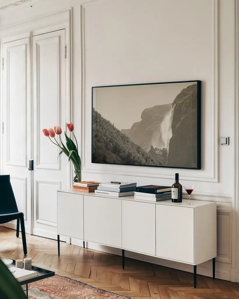 Western Brook Pond Falls Sepia by Nathan Larson. shown as a framed stretched canvas in a living room above a console. Available as a archival giclee rolled canvas, fine art paper, or poster print. SKU 101658i.
