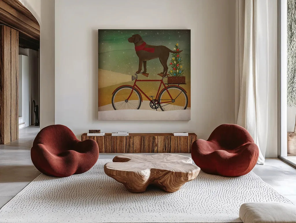Brown Lab on Bike Christmas by Ryan Fowler. Shown as extra-large giant wall art in a modern living room. Available as an archival giclee rolled canvas, fine art paper, or poster print. SKU 31273a.