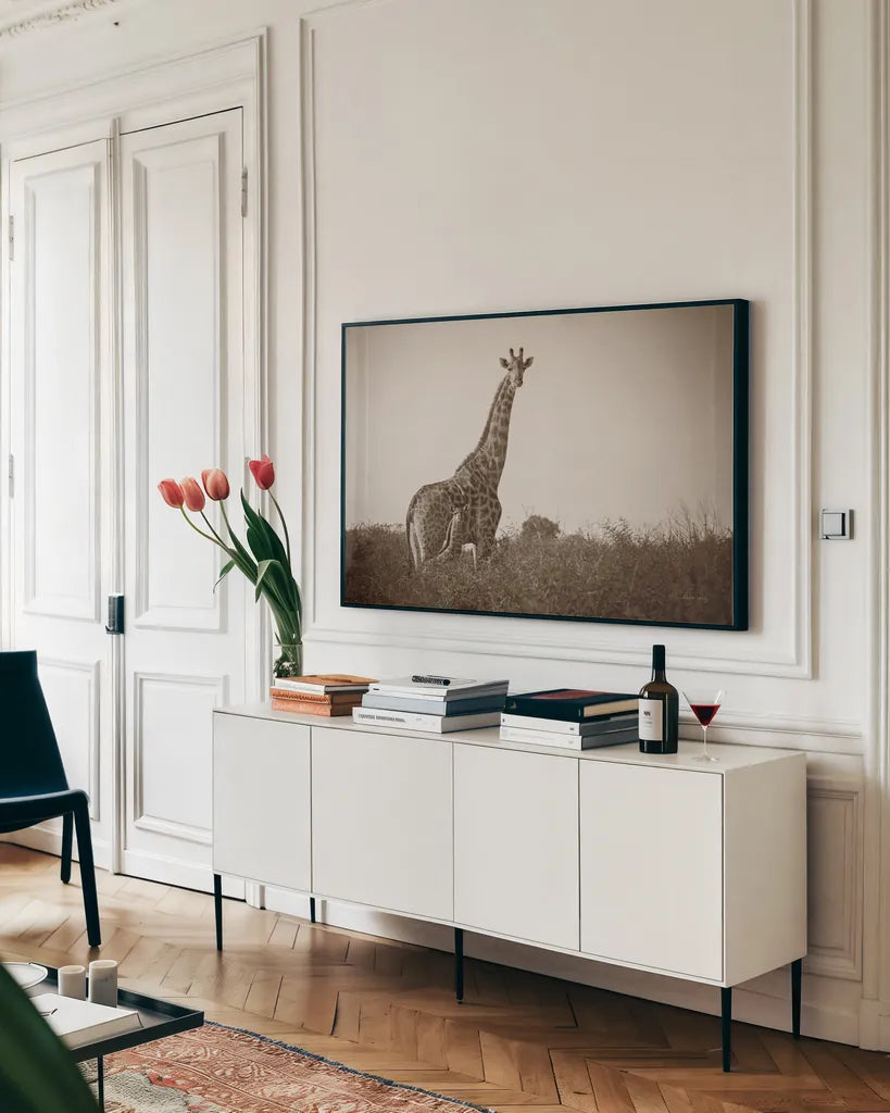 Giraffe and Baby Sepia by Sharon Vardy. shown as a framed stretched canvas in a living room above a console. Available as a archival giclee rolled canvas, fine art paper, or poster print. SKU 93123i.