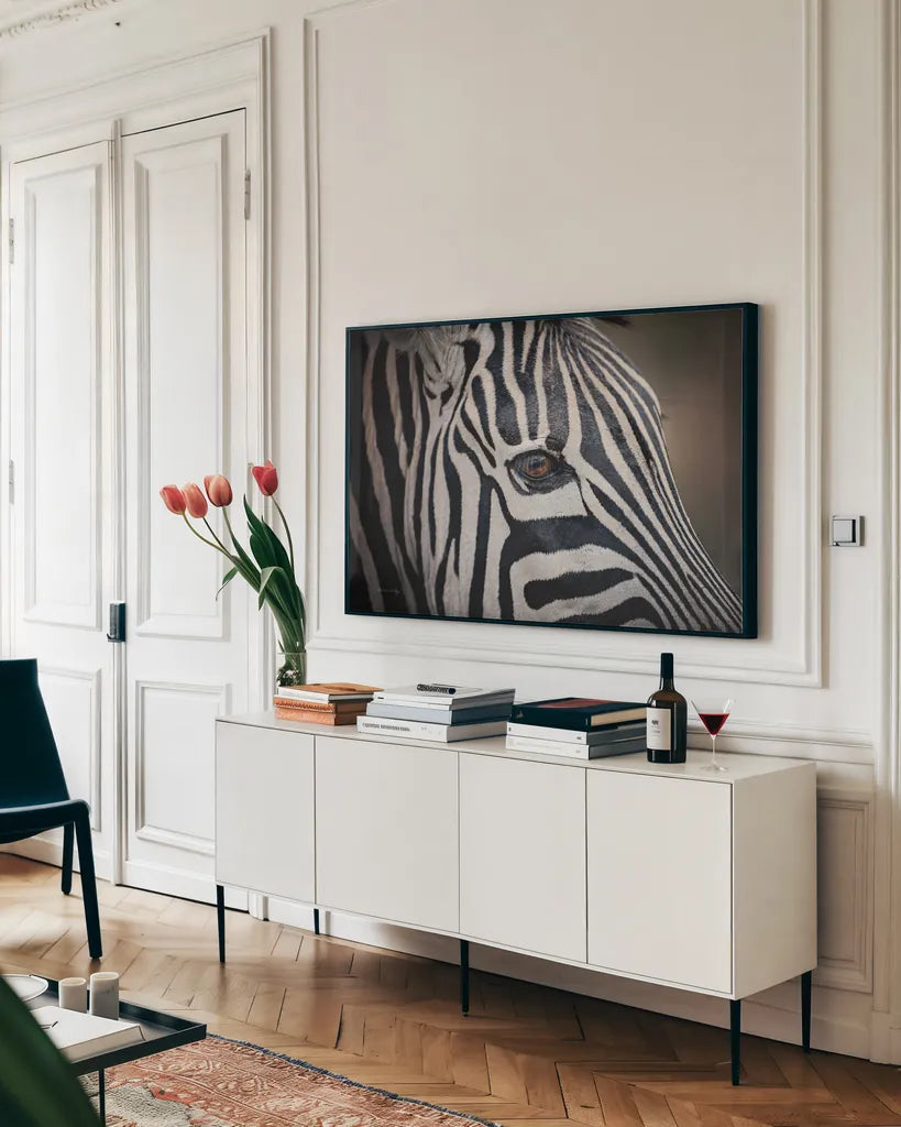 Zebra Face by Sharon Vardy. shown as a framed stretched canvas in a living room above a console. Available as a archival giclee rolled canvas, fine art paper, or poster print. SKU 91983i.