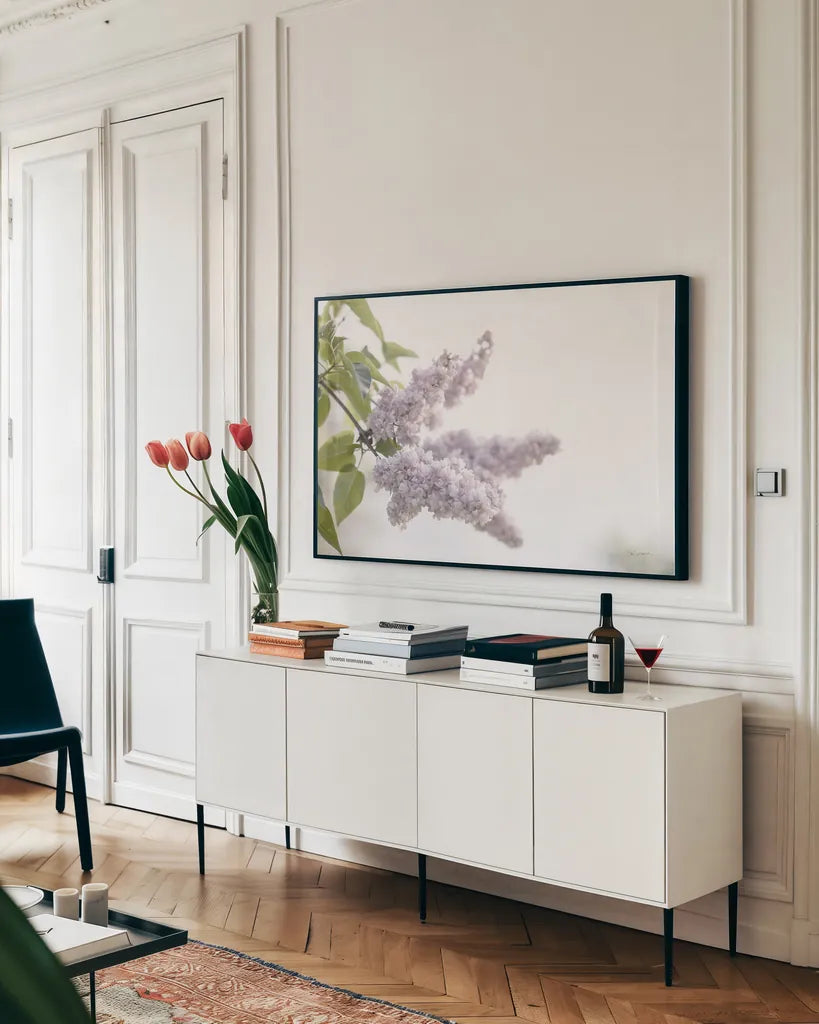 Pale Lilacs I by Sue Schlabach. shown as a framed stretched canvas in a living room above a console. Available as a archival giclee rolled canvas, fine art paper, or poster print. SKU 72129i.