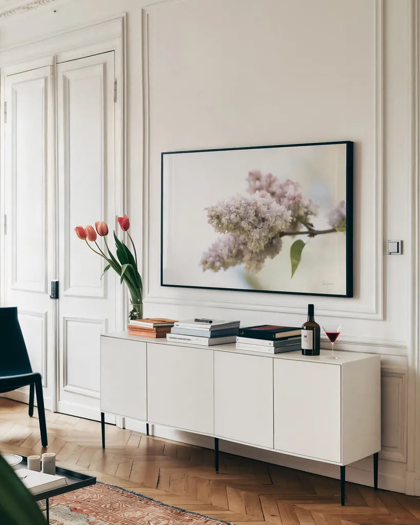 Pale Lilacs II by Sue Schlabach. shown as a framed stretched canvas in a living room above a console. Available as a archival giclee rolled canvas, fine art paper, or poster print. SKU 72130i.