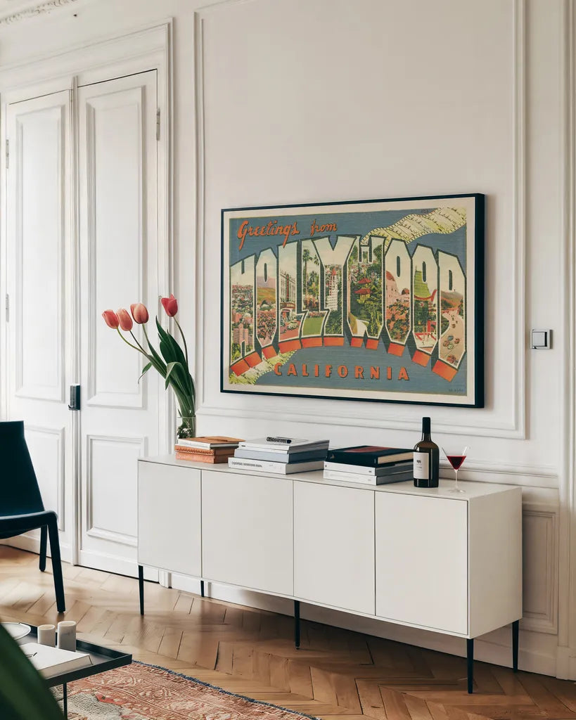 Greetings from Hollywood v2 by Wild Apple Portfolio. shown as a framed stretched canvas in a living room above a console. Available as a archival giclee rolled canvas, fine art paper, or poster print. SKU 45240i.