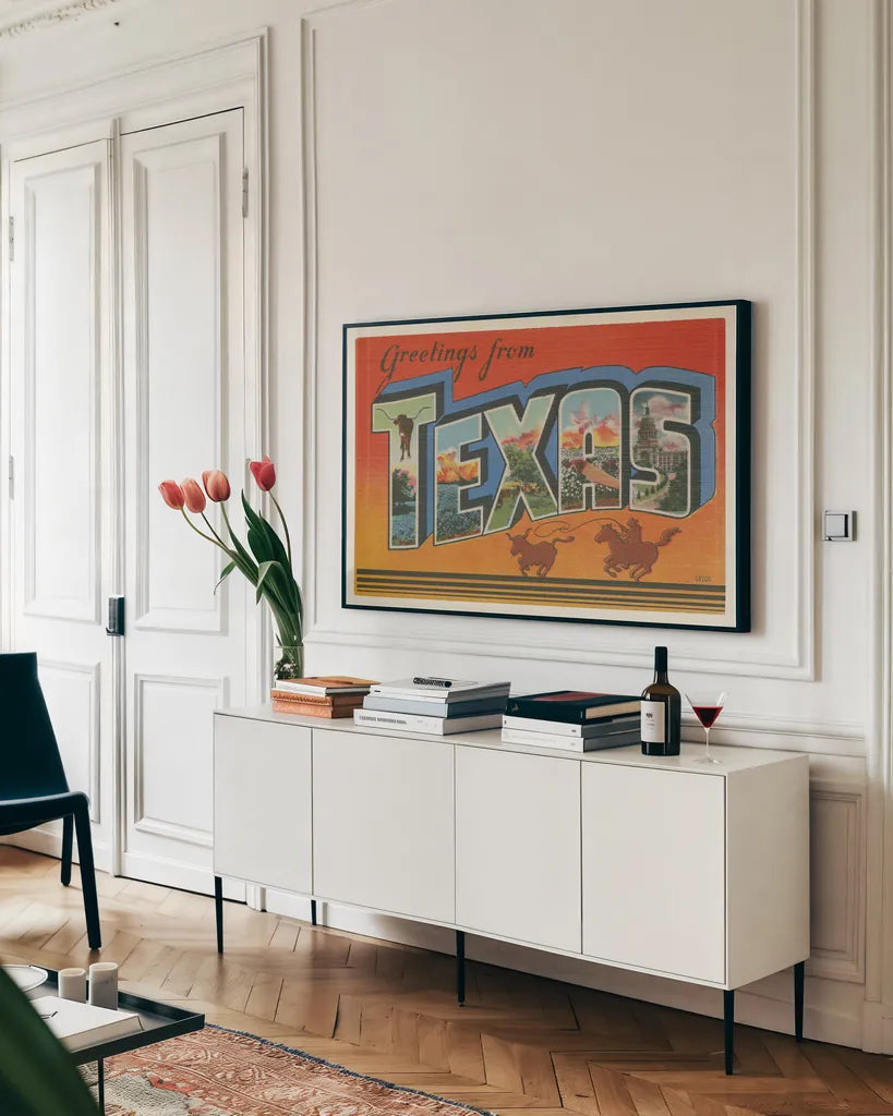Greetings from Texas v2 by Wild Apple Portfolio. shown as a framed stretched canvas in a living room above a console. Available as a archival giclee rolled canvas, fine art paper, or poster print. SKU 45243i.