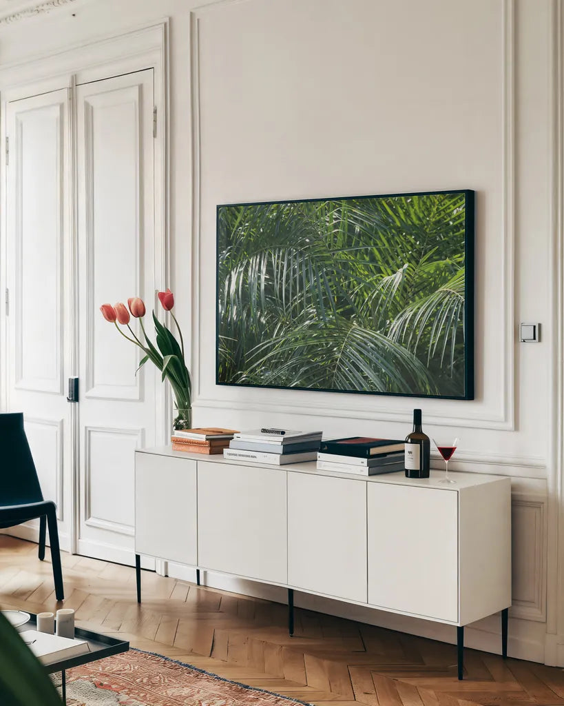 Tropical Fronds by Wild Apple Portfolio. shown as a framed stretched canvas in a living room above a console. Available as a archival giclee rolled canvas, fine art paper, or poster print. SKU 56308i.