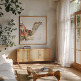 Desert Camel I by Aimee Del Valle. Shown in a natural wood frame in a cozy modern living room. Available as an archival giclee rolled canvas, fine art paper, or poster print. SKU 67717a.