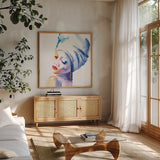 Woman in Blue Crop by Aimee Del Valle. Shown in a natural wood frame in a cozy modern living room. Available as an archival giclee rolled canvas, fine art paper, or poster print. SKU 65111a.