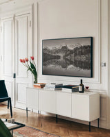 Alice Lake Sawtooth Mountains Idaho BW by Alan Majchrowicz. shown as a framed stretched canvas in a living room above a console. Available as a archival giclee rolled canvas, fine art paper, or poster print. SKU 81523i.