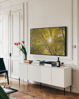 Autumn Foliage Sunburst V by Alan Majchrowicz. shown as a framed stretched canvas in a living room above a console. Available as a archival giclee rolled canvas, fine art paper, or poster print. SKU 52766i.