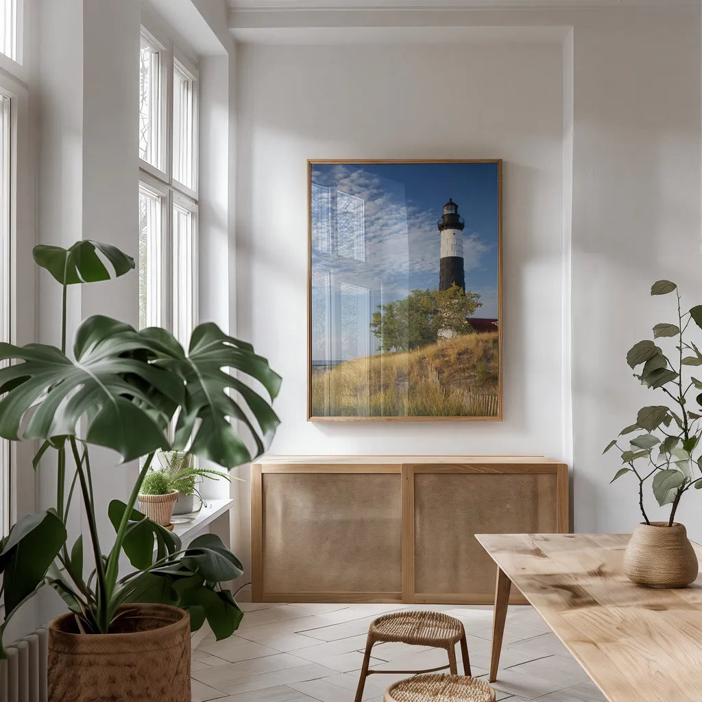 Big Sable Point Lighthouse II by Alan Majchrowicz. shown as a print in a natural wood frame in a dining room. Available as a archival giclee rolled canvas, fine art paper, or poster print. SKU 50033h.