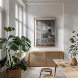 Big Sable Point Lighthouse II BW by Alan Majchrowicz. shown as a print in a natural wood frame in a dining room. Available as a archival giclee rolled canvas, fine art paper, or poster print. SKU 50035h.