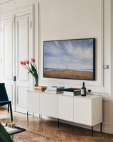 Cattle Point Lighthouse by Alan Majchrowicz. shown as a framed stretched canvas in a living room above a console. Available as a archival giclee rolled canvas, fine art paper, or poster print. SKU 86299i.