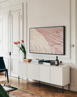 Coyote Buttes VI Blush by Alan Majchrowicz. shown as a framed stretched canvas in a living room above a console. Available as a archival giclee rolled canvas, fine art paper, or poster print. SKU 53658i.
