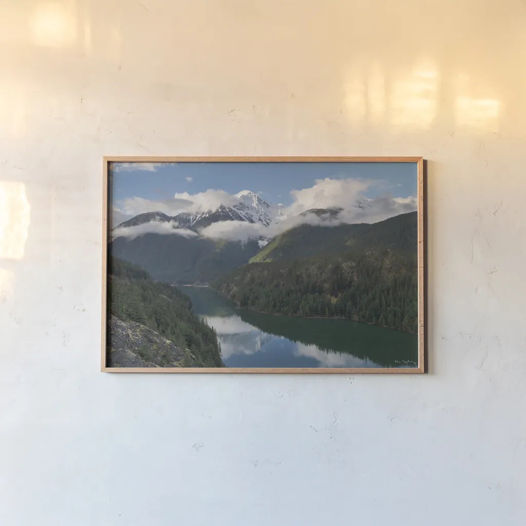 Diablo Lake and Colonial Peak by Alan Majchrowicz. shown as a paper print in a natural frame. Available as a archival giclee rolled canvas, fine art paper, or poster print. SKU 101145i.