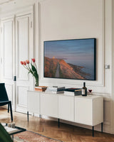 Evening Light Over Cattle Point by Alan Majchrowicz. shown as a framed stretched canvas in a living room above a console. Available as a archival giclee rolled canvas, fine art paper, or poster print. SKU 86300i.