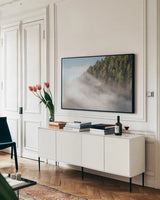 Fog and Forest I by Alan Majchrowicz. shown as a framed stretched canvas in a living room above a console. Available as a archival giclee rolled canvas, fine art paper, or poster print. SKU 77234i.