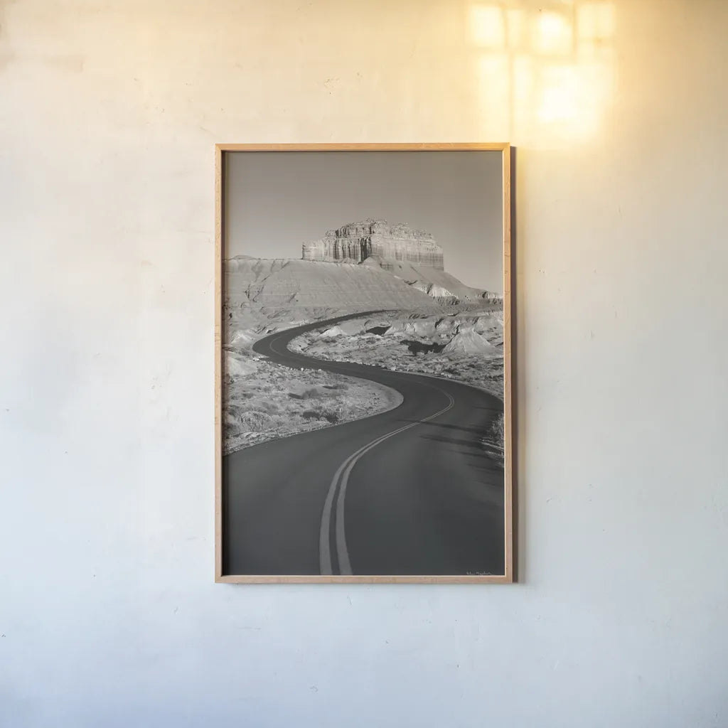 Goblin Valley State Park Rd BW by Alan Majchrowicz. shown as a paper print in a natural frame. Available as a archival giclee rolled canvas, fine art paper, or poster print. SKU 81527h.