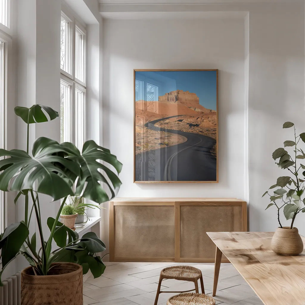 Goblin Valley State Park Road by Alan Majchrowicz. shown as a print in a natural wood frame in a dining room. Available as a archival giclee rolled canvas, fine art paper, or poster print. SKU 81526h.