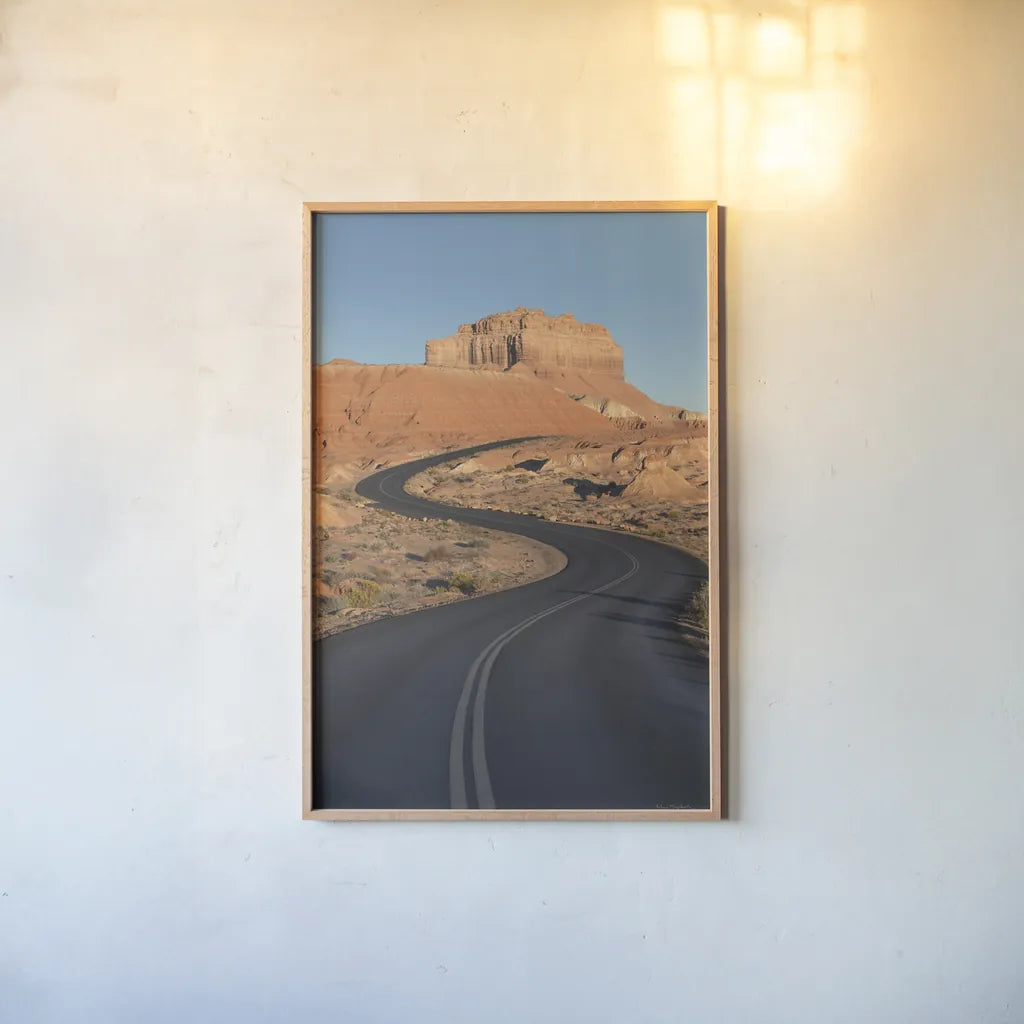 Goblin Valley State Park Road by Alan Majchrowicz. shown as a paper print in a natural frame. Available as a archival giclee rolled canvas, fine art paper, or poster print. SKU 81526h.