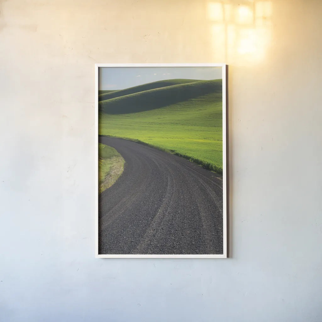 Going Through Palouse Wheat Fields by Alan Majchrowicz. shown as a paper print in a white frame. Available as a archival giclee rolled canvas, fine art paper, or poster print. SKU 62464h.