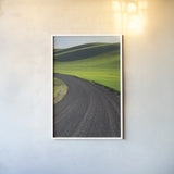 Going Through Palouse Wheat Fields by Alan Majchrowicz. shown as a paper print in a white frame. Available as a archival giclee rolled canvas, fine art paper, or poster print. SKU 62464h.