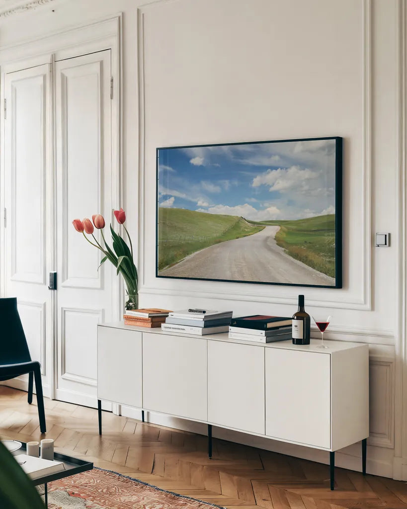 Gravel Road Near Choteau Montana I by Alan Majchrowicz. shown as a framed stretched canvas in a living room above a console. Available as a archival giclee rolled canvas, fine art paper, or poster print. SKU 62460i.