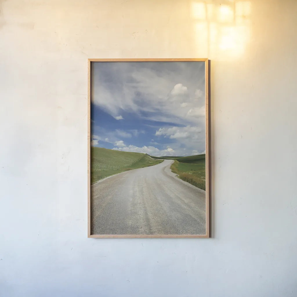 Gravel Road Near Choteau Montana II by Alan Majchrowicz. shown as a paper print in a natural frame. Available as a archival giclee rolled canvas, fine art paper, or poster print. SKU 62461h.